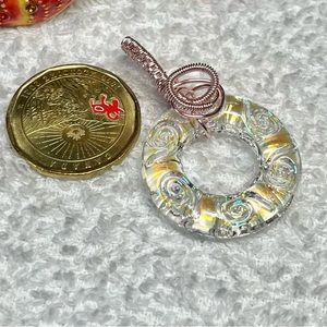 Pink wire wrapped titanium donut bead pendant